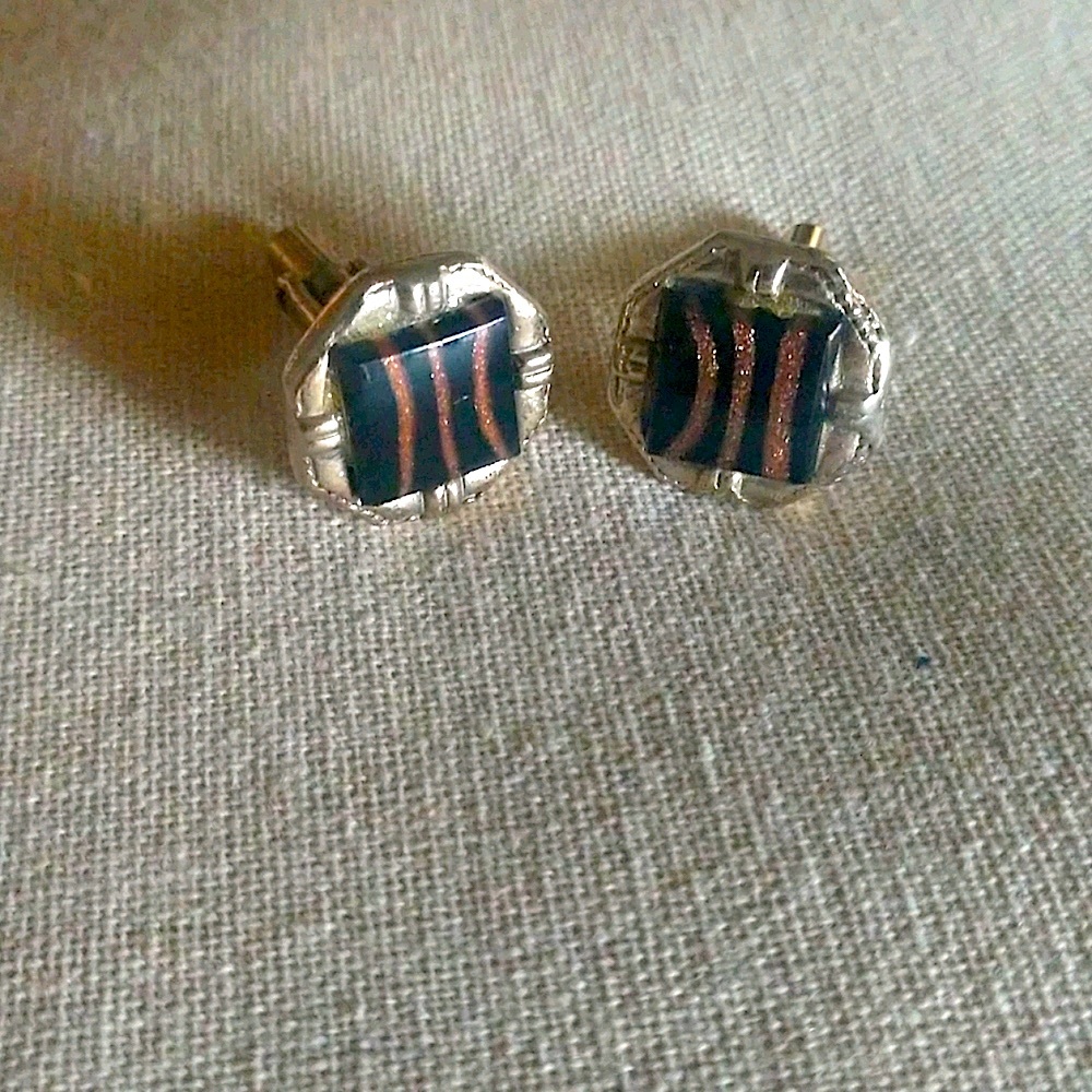 Bullet back style black and gold cufflinks.